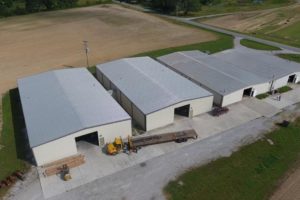 four warehouses with a truck in front viewed from above